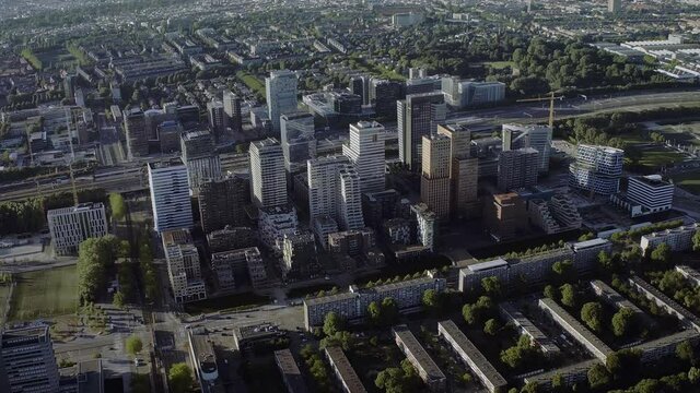 Aerial view of The Zuidas in Amsterdam on a sunny day. Financial Mile. Netherlands financial district with many buildings. It is located between the Amstel river and the A10 ringway.