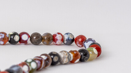 Close up colorful men's Muslim Prayer beads on white background 