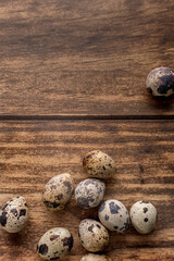 Easter picture with quail eggs on a wooden background. The minimal concept of Easter.  An Easter card with a place for the text. Blurred background.