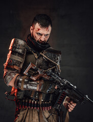 Fototapeta na wymiar Apocalyptic suvivor holding shotgun in dark background