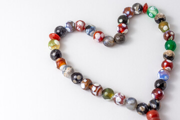 Colorful men's Muslim Prayer beads heart shape on white background 