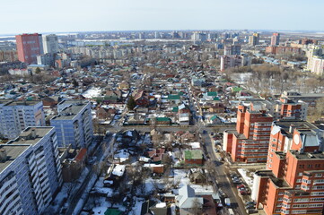 Fototapeta premium view of the city and multi-storey and one-storey buildings on a sunny day