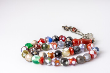 Close up colorful men's Muslim Prayer beads on white background, Ramadan concept 