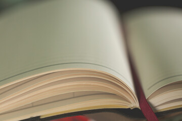 A white pencil on white notebook on wooden table background, Close up
