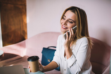 Cheerful woman using smartphone for making call