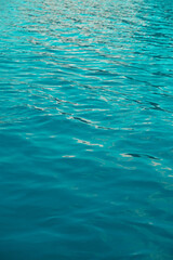 Abstract background turquoise water surface. Wallpaper with waves form ripples
