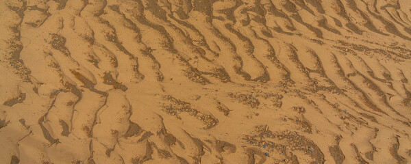 Rippled golden brown desert sand Texture background
