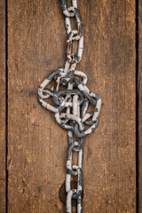 Knotted chain on a wooden plank