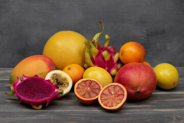 Assortment of tropical fruits on wood table.