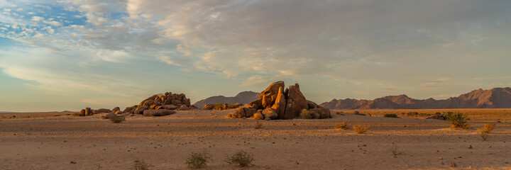 Fototapeta na wymiar Rocky sunset landscape of Namib-Naukluft National Park at Sesriem, Sossusvlei, part of the Namib Desert