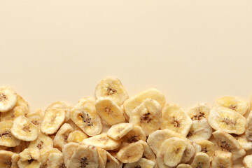Composition with sweet dried banana slices on a color background. Dried fruit as healthy snack