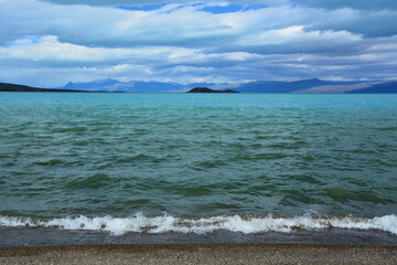 Wonderful view of the lake with small waves on a cloudy day.