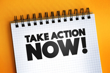 Take Action Now text quote on notepad, concept background