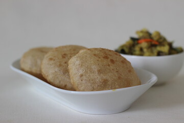 Puri and Potato masala curry. Its a deep fat fried bread made from whole wheat flour served with potato masala curry.
