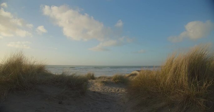 Sand dunes by the beach on sunny afternoon at Perran Sands, North Cornish coast