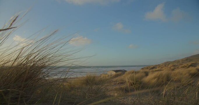Strong wind blowing through sand dunes at Perran Sands Beach, shaky