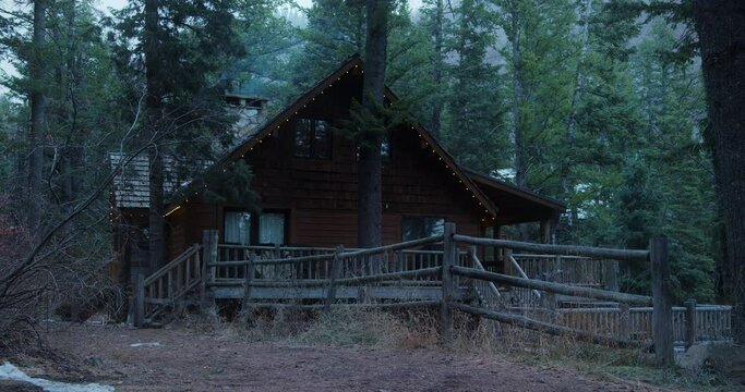 Wide shot, log cabin in forest landscape