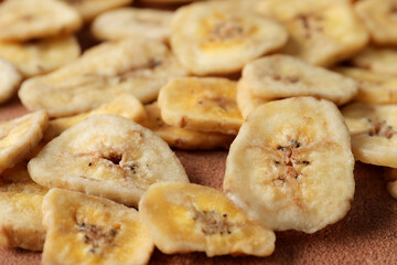 Heap of sweet banana slices on  a  background. Dried fruit as healthy snack