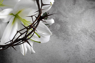 Good Friday, Passion of Jesus Christ. Crown of thorns, nails and white lily on grey background. Christian Easter holiday.