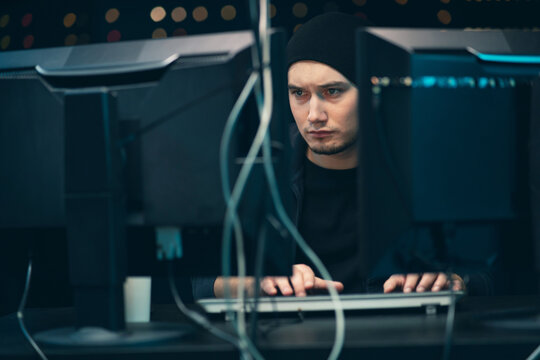 A young, tired hacker with dark circles under his eyes breaks into the company's data servers from his underground dark and gloomy hideout. He works on a computer with data in a temporary server room