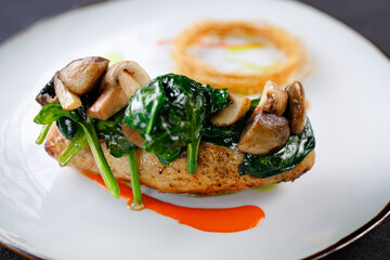 Chicken breasts with cheese and vegetable garnish