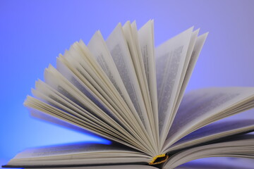 Reading books and literature.Open book on a blue background.  book pages.Learning and knowledge concept. 