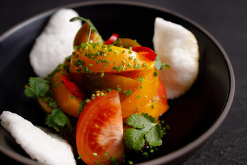 Salad of various tomatoes, healthy vegan food
