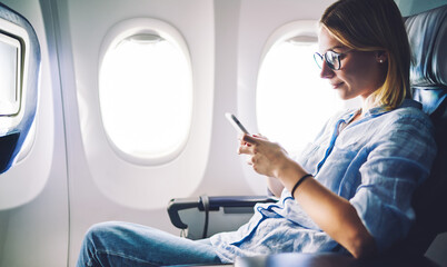 Passenger using mobile phone in airplane