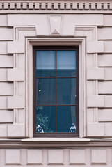 Fototapeta na wymiar Windows in the city in the old style, with stucco, decorative elements