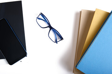 Book vs. e-book. Eyeglasses, books and e-books isolated on white background. Choose between paper...
