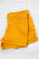 folded shorts close up top view on wooden background
