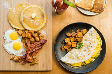 Huevos Rancheros and a Slam Breakfast.  Three scrambled eggs in a flour tortilla with refried...