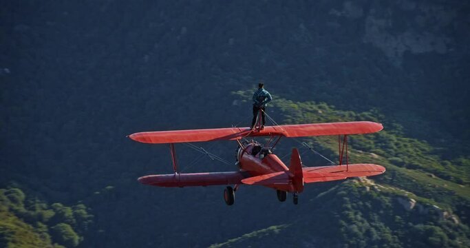 Aerial, stuntman on top of vintage plane
