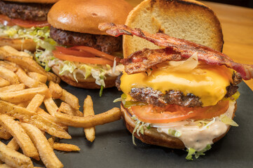 Bacon cheese burger platter with fries at a diner style restaurant.