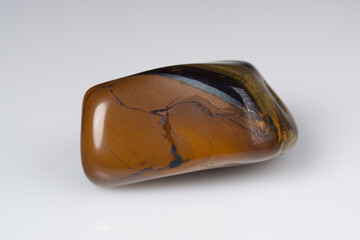 Natural gem tiger's eye on a white background
