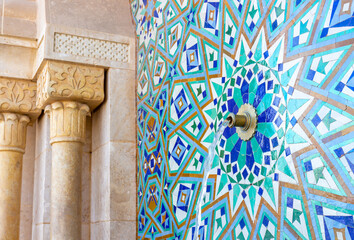 Ablution fountain before prayer decorated with traditional mosaic geometric patterns in front of...