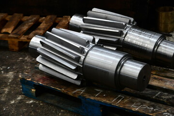 Gear shaft on a rack made on a gear hobbing machine.