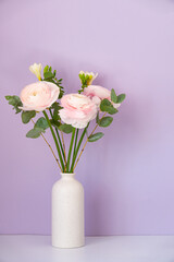 Persian buttercup. Bunch pale pink ranunculus flowers light background.