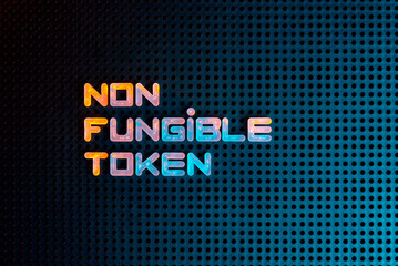 NFT nonfungible tokens text from letters glowing with neon light on a dark background