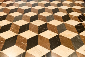 Brown, black, light rhombic texture on the floor. Rhombic slab. 