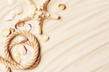Background of sand decorated with rope and shells, summer travel concept