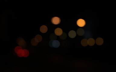 Blurred, bokeh of car lights at dark night in the city. Colorful blurry abstract background.