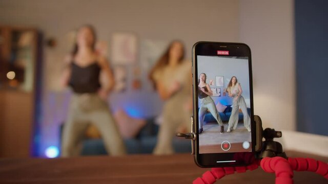 Teenagers womans shooting together dancing at home when making video for social media, stories hip hop popular trandy dance, students at home make content