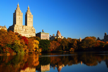 Fototapeta na wymiar The luxury apartment buildings of Manhattan rise over the autumn foliage of Central Park