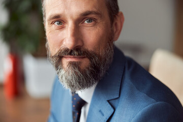Fototapeta premium Portrait of aged busenessman in a modern office