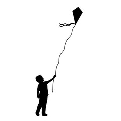 Silhouette little boy flying kite.