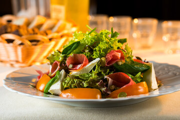 vegetable salad with cheese and ham on a platter in a restaurant