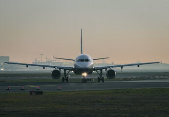 Fototapeta na wymiar Frankfurt, Hesse, Germany, 07.04.2019: frontal image of a commercial passenger airplane on a taxiway during sunrise. 