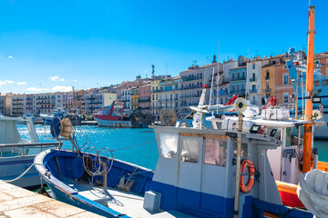 Sète in France, fisherboat at the quay, typical colorful facades.