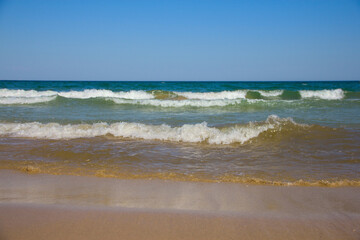 Sea waves and sandy beach